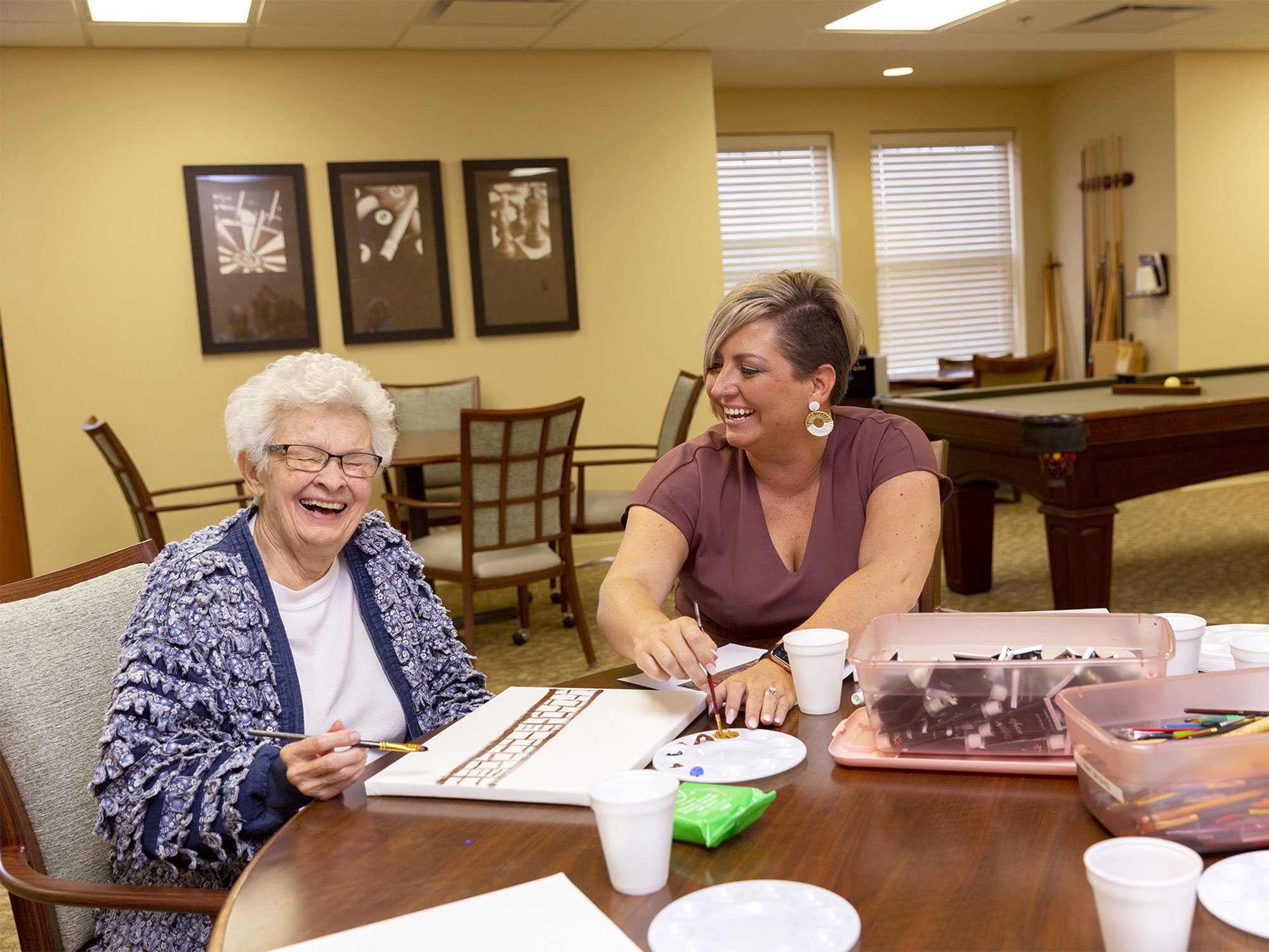 StoryPoint Group resident painting with employee 