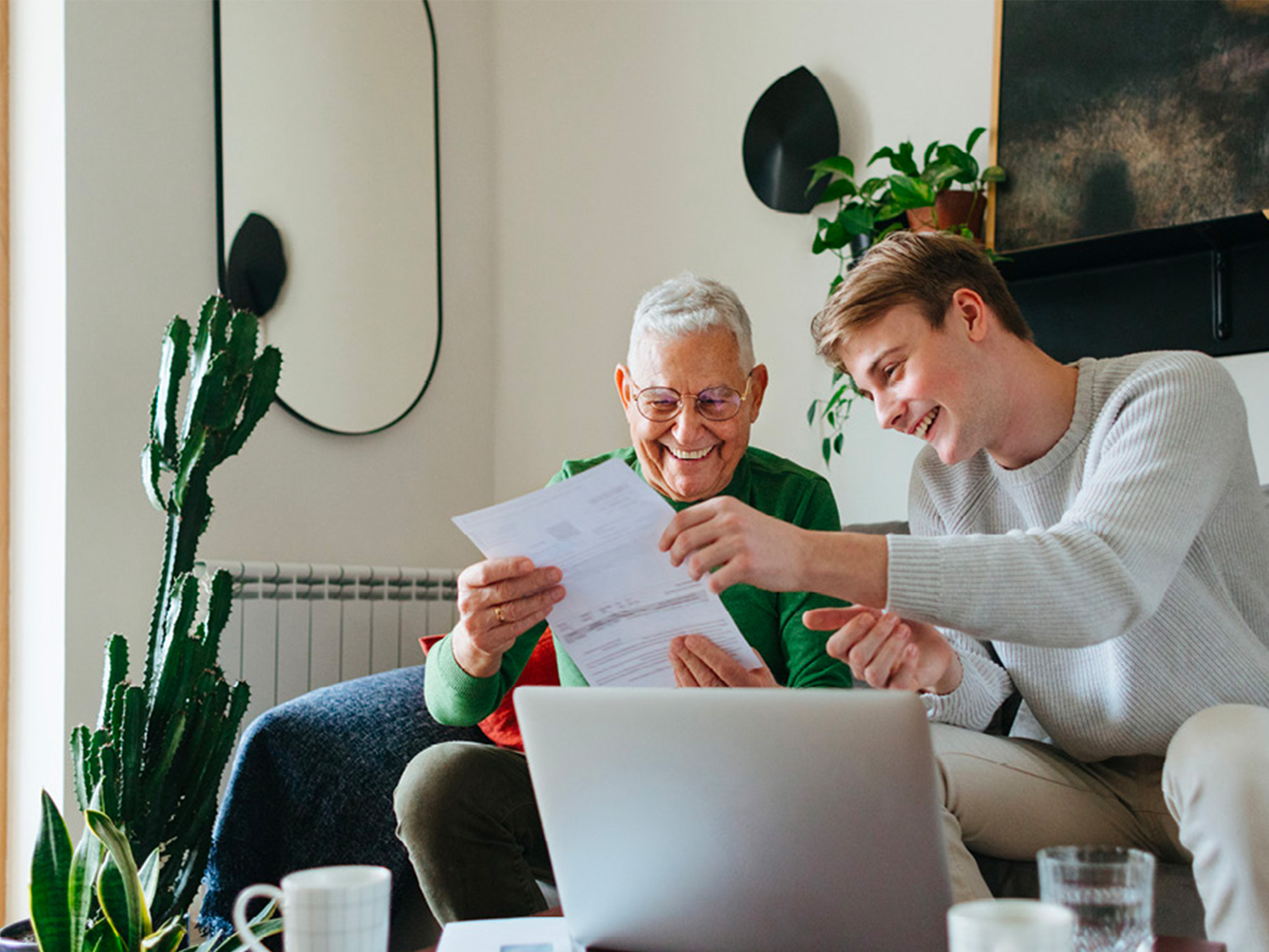 senior looking at a document with his grandson