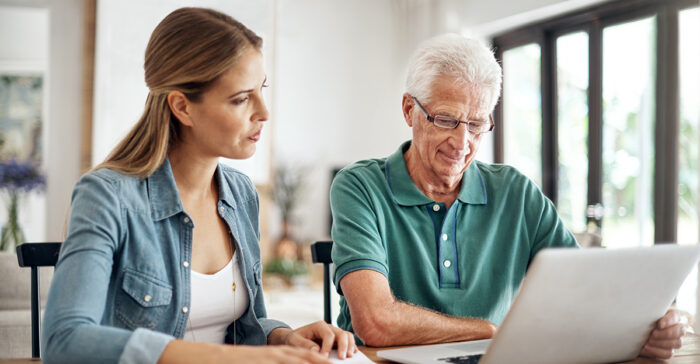 senior on the computer with his daughter