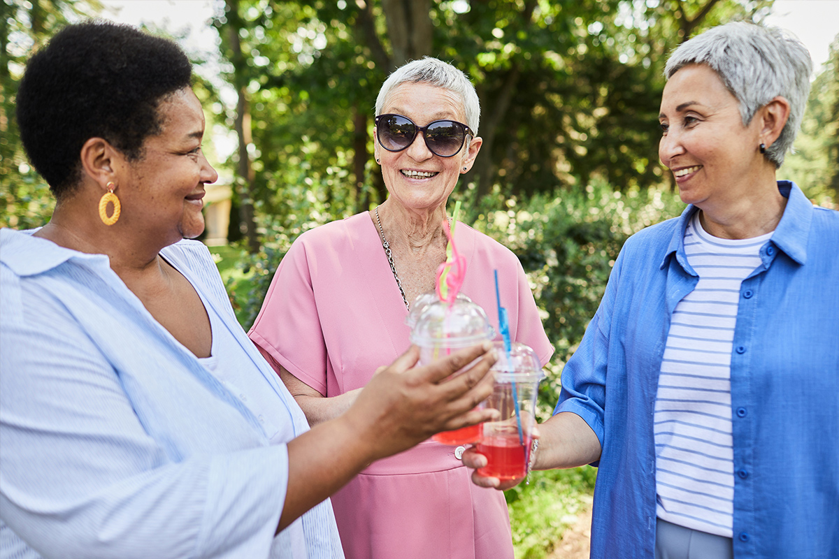 Seniors outside sharing drinks