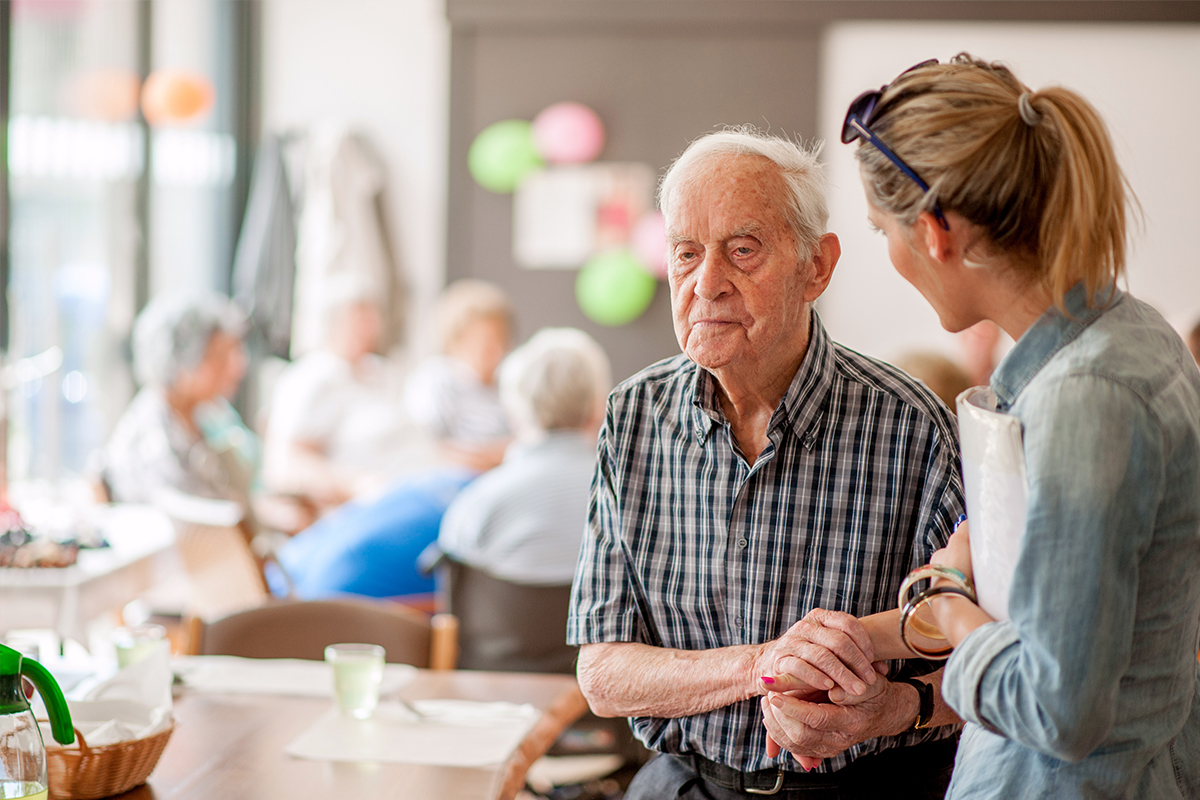 Senior holding hands with caregiver