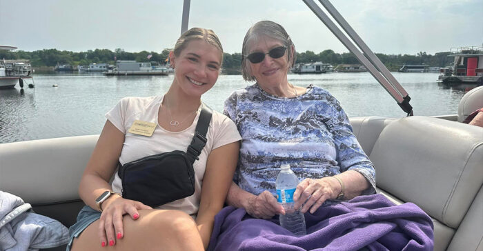 senior caregiver and resident on a boat ride