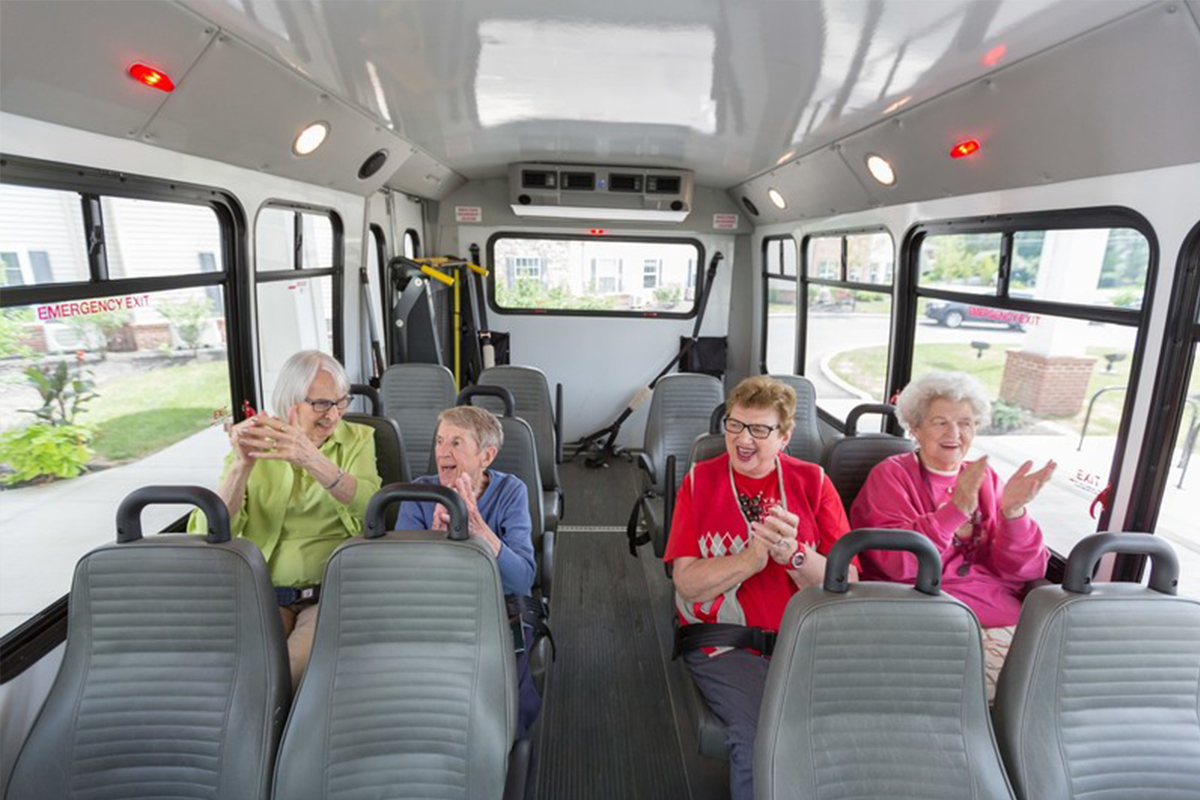 StoryPoint Residents clapping their hands on a bus