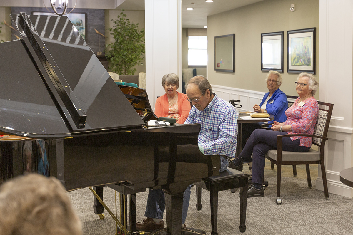 senior playing the piano