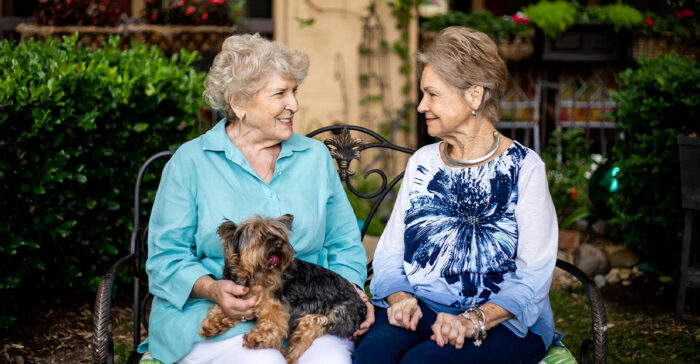 senior living residents holding a dog