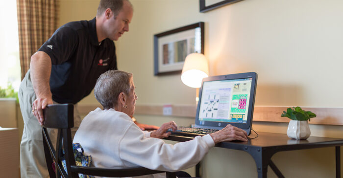 senior on the computer with their adult son