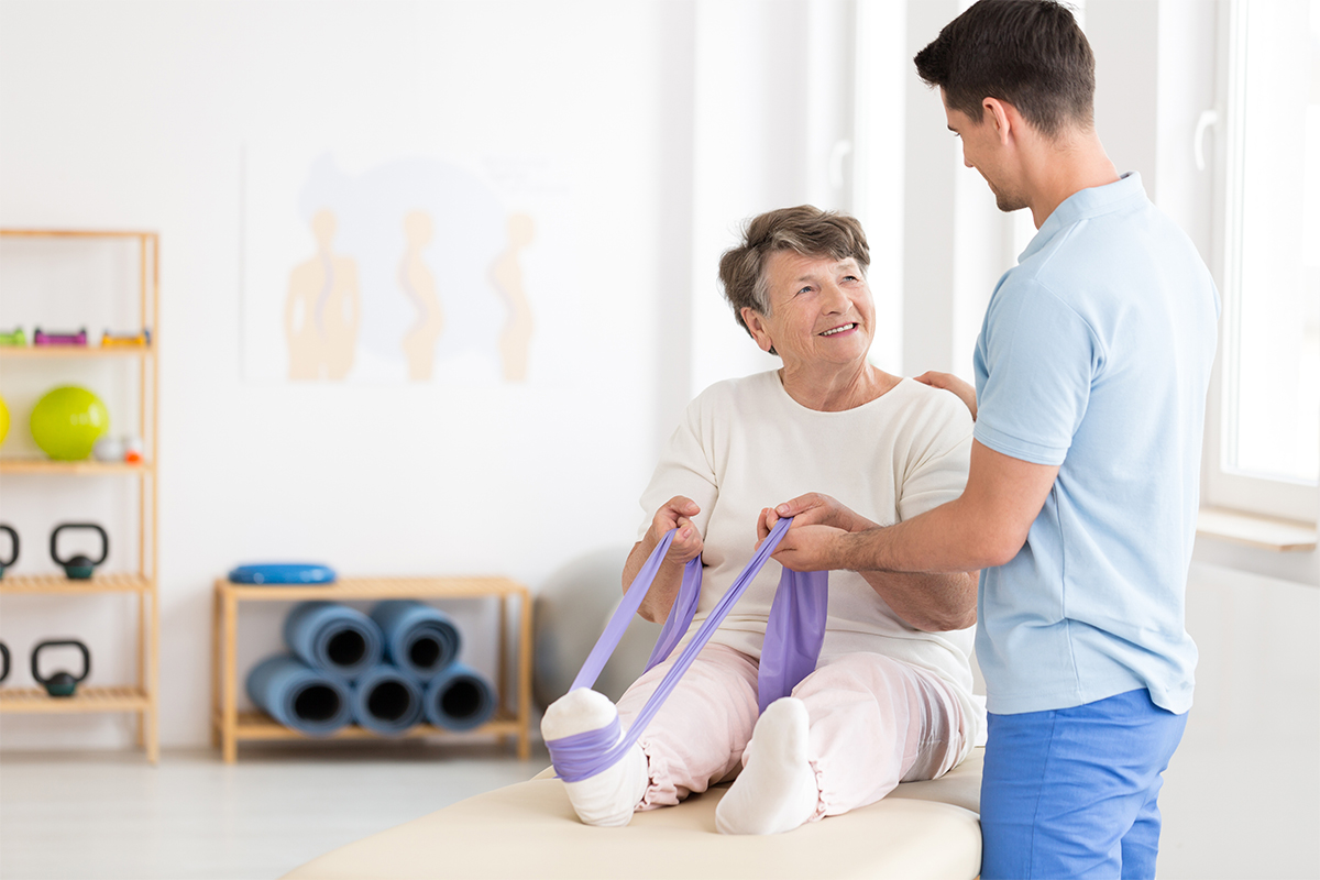 senior with physical therapist