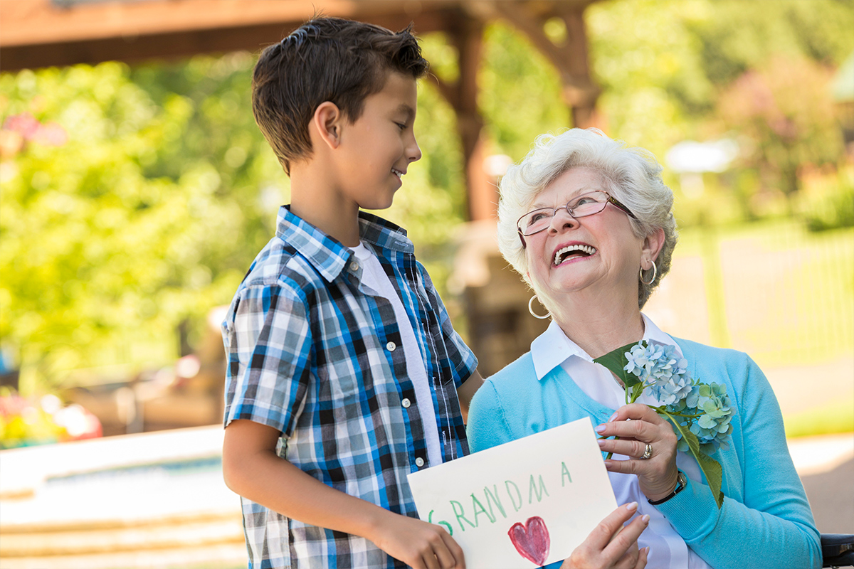 grandson giving his grandma a gift