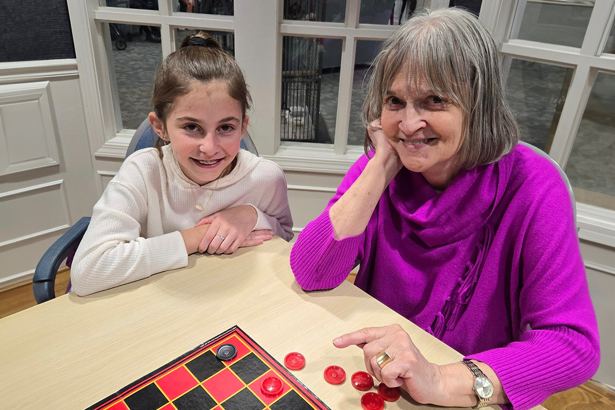 StoryPoint Resident and grandchild playing checkers