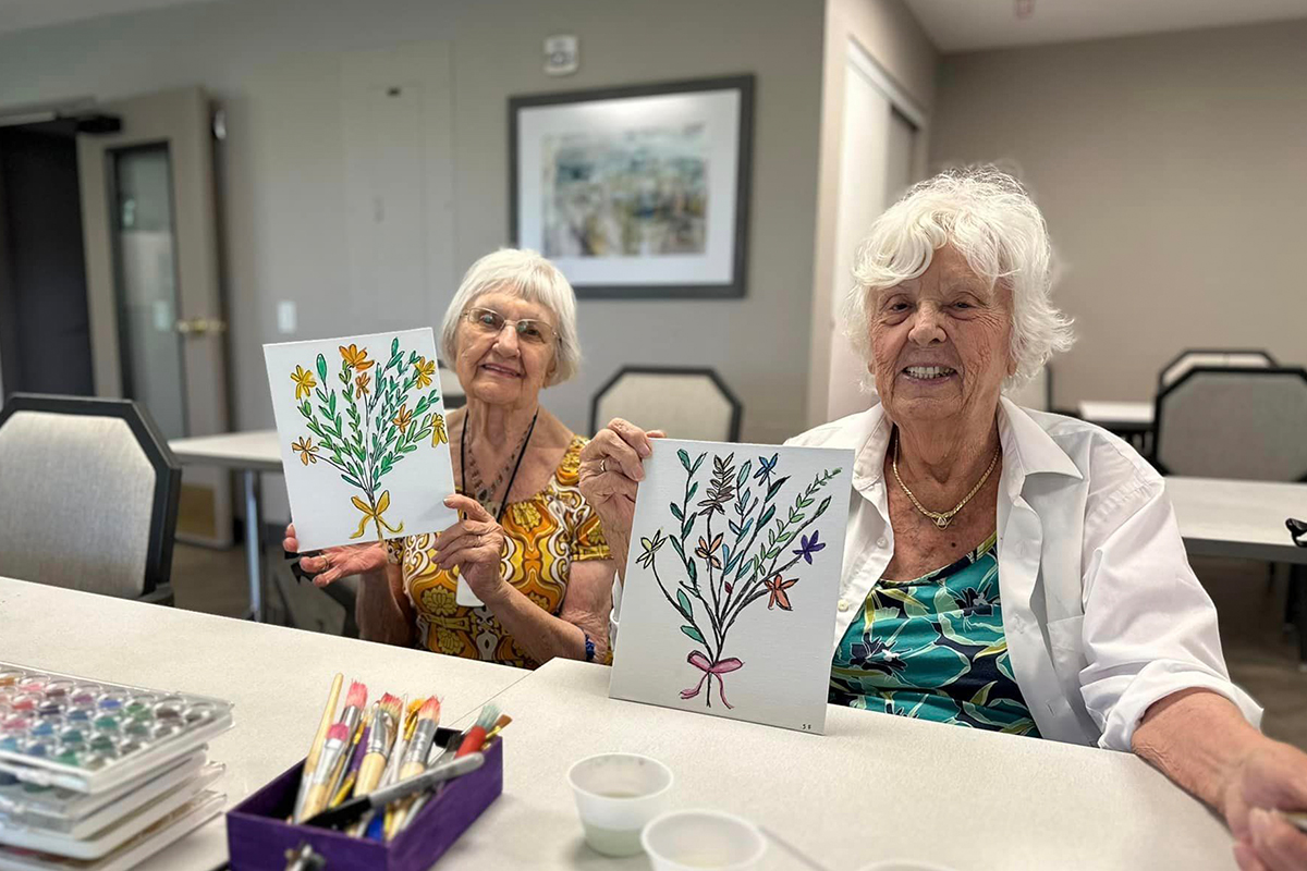 StoryPoint Residents showing off their paintings