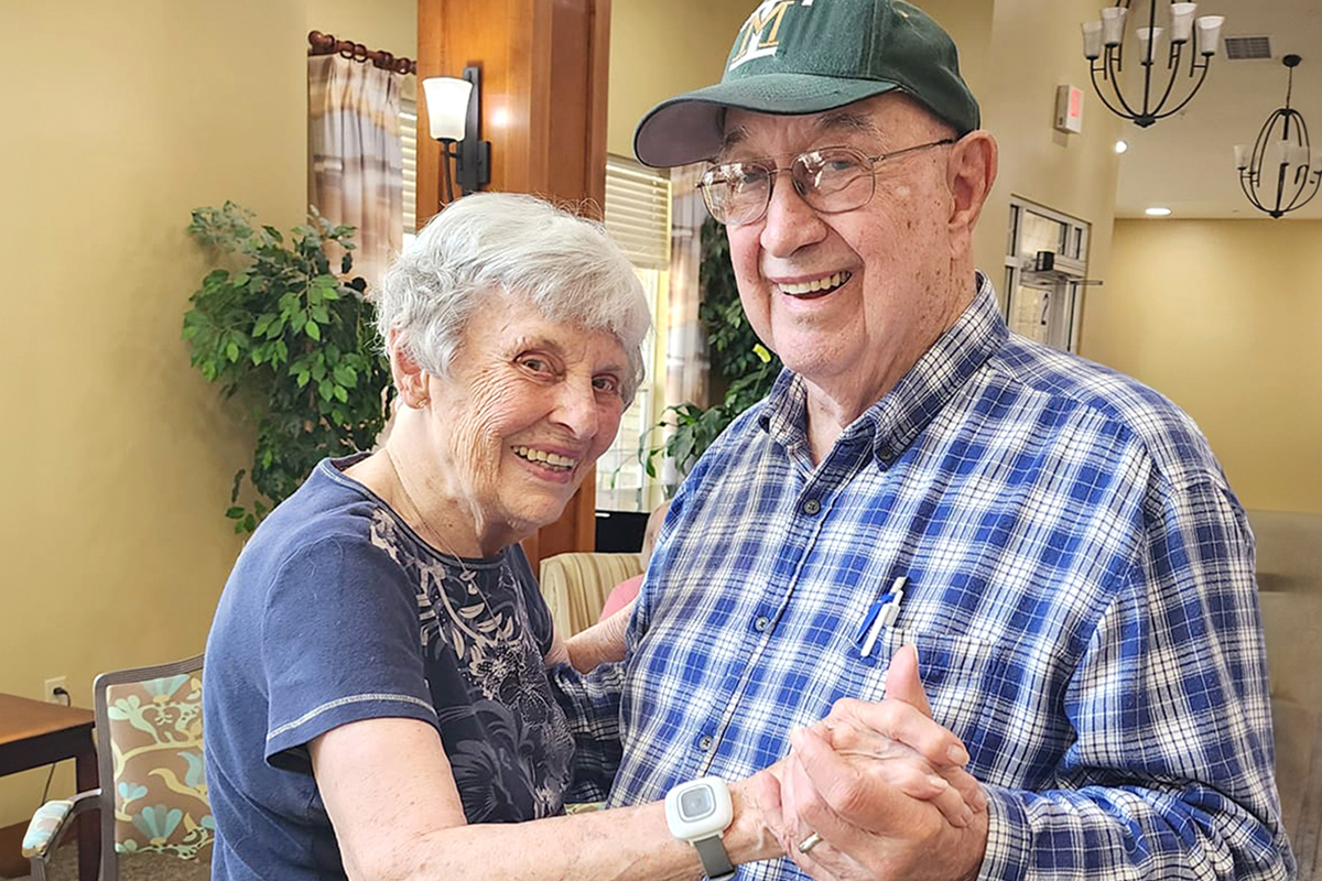 a couple in assisted living dancing