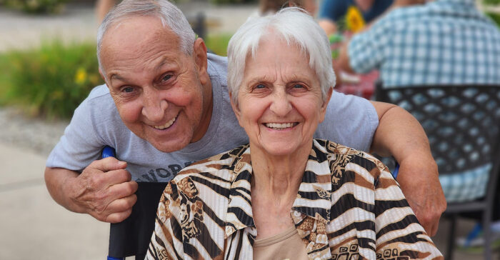 A couple in assisted living smiling