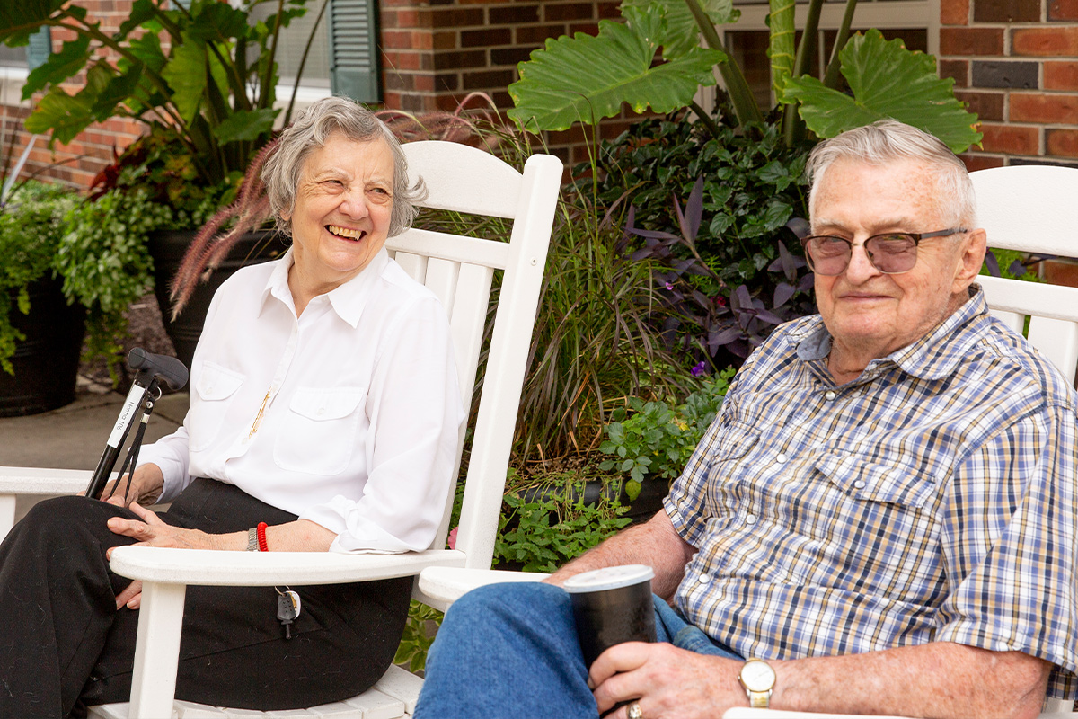 a couple in assisted living siting outside