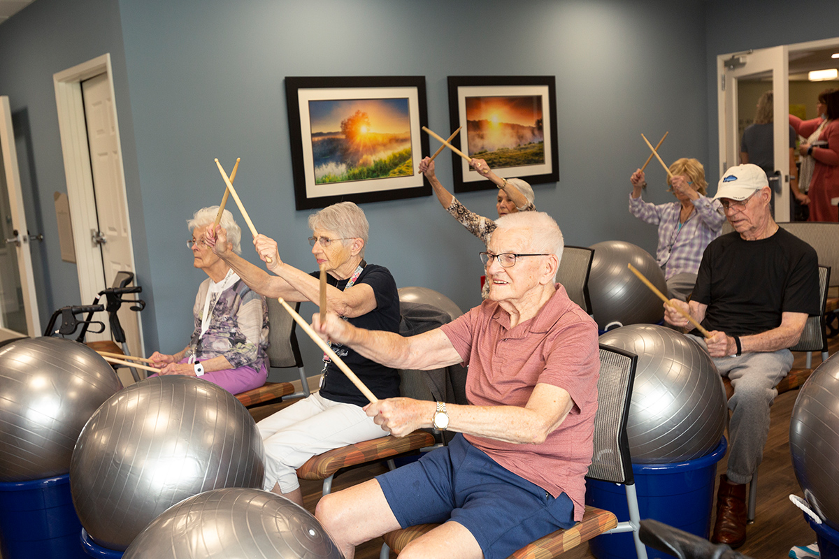 Senior group playing with drums