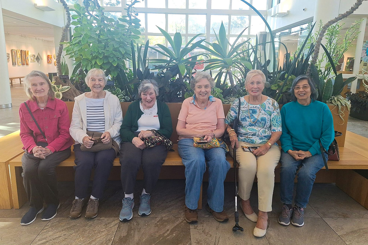 StoryPoint Cordova residents sitting on a bench together.