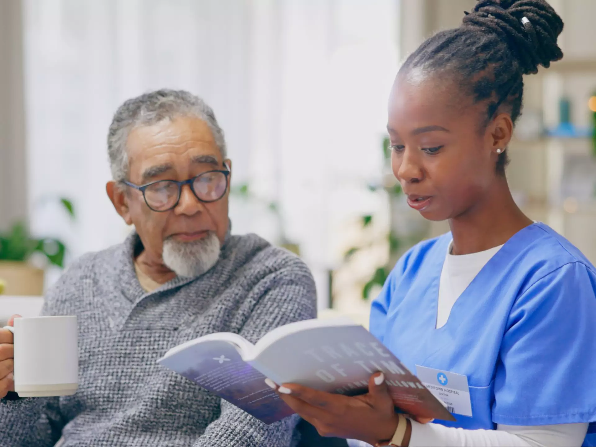 in home caregiver reading something to a patient 