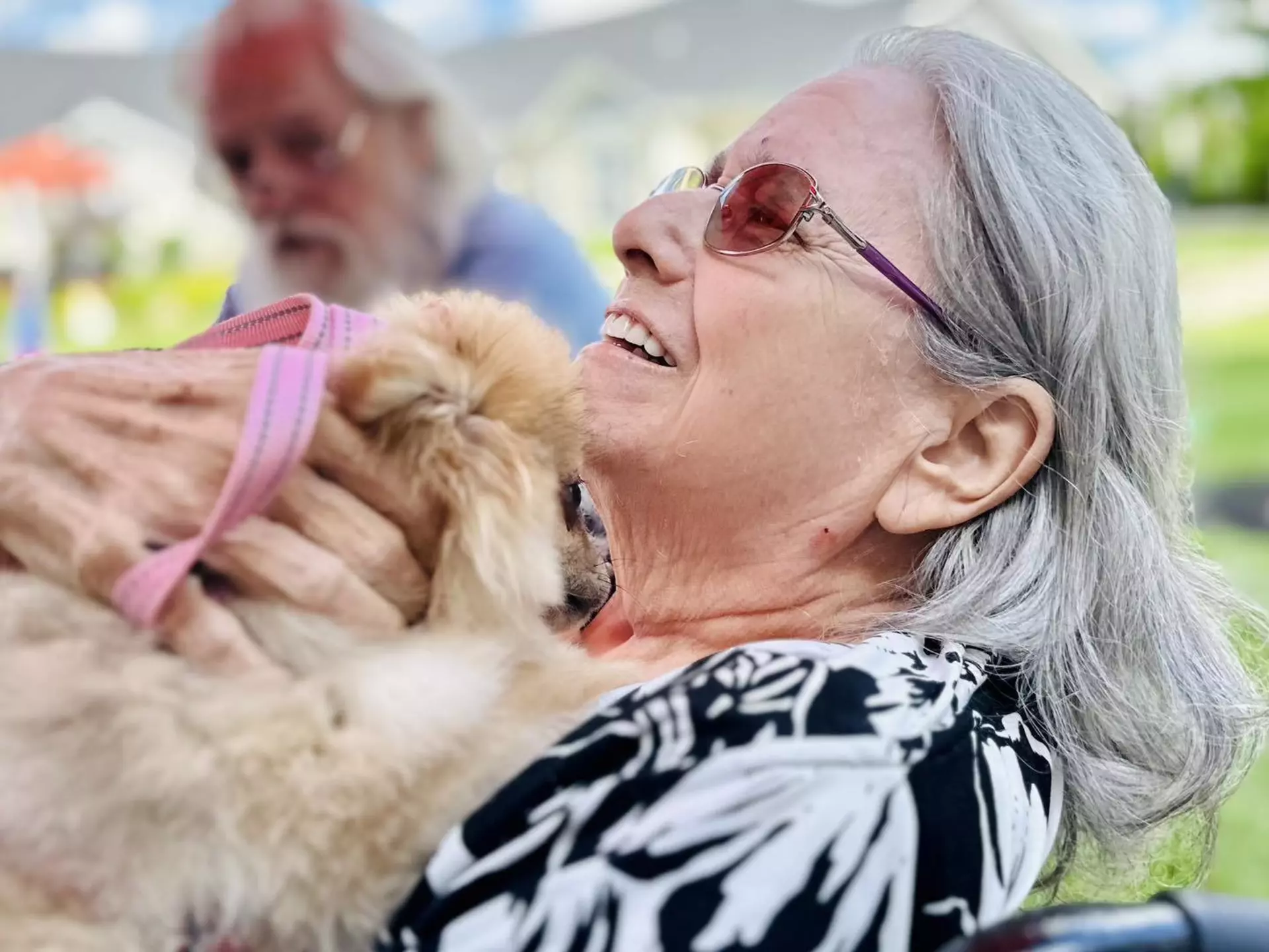assisted living resident holding a dog