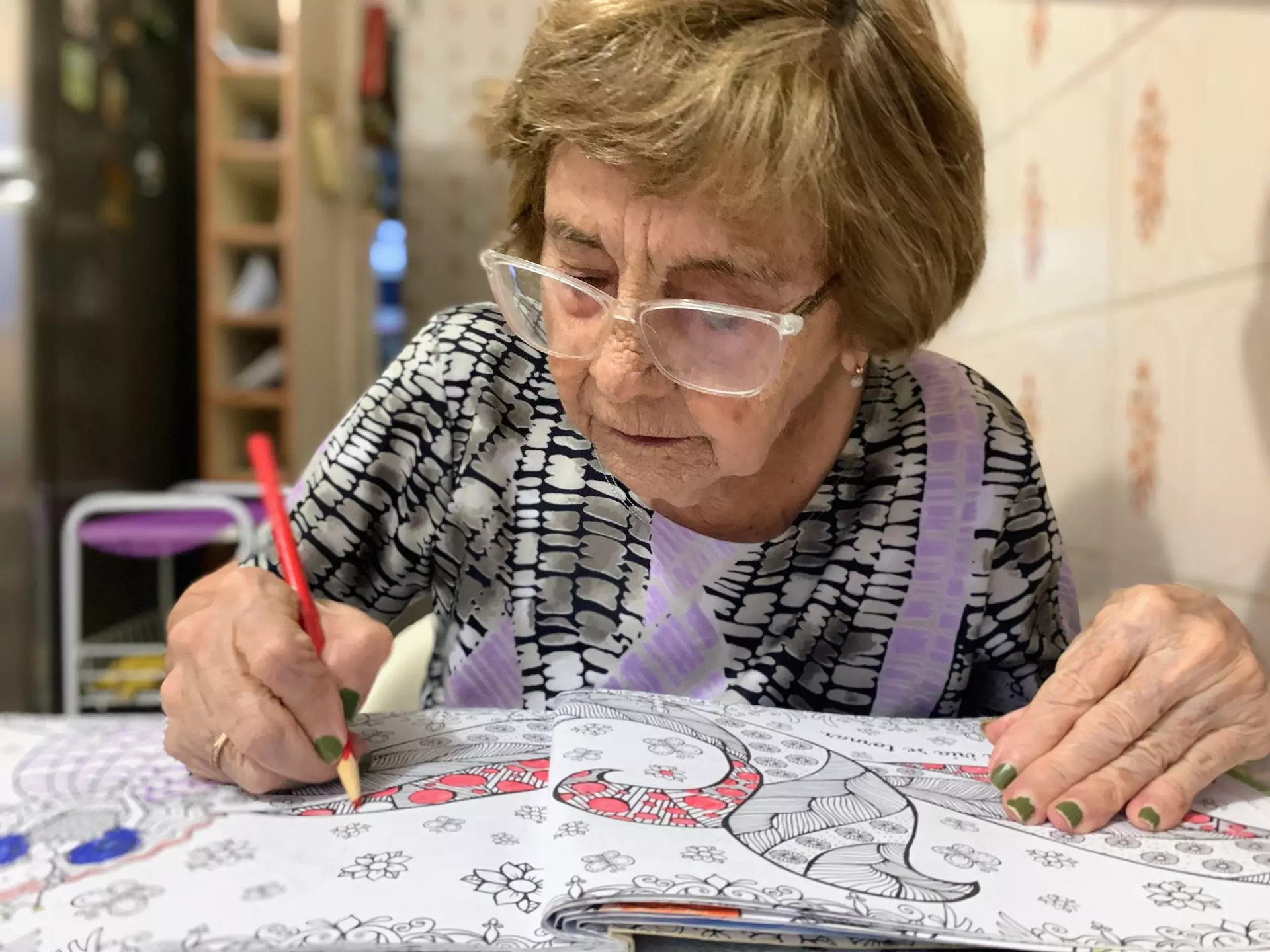 A StoryPoint Group resident is coloring with colored pencils.